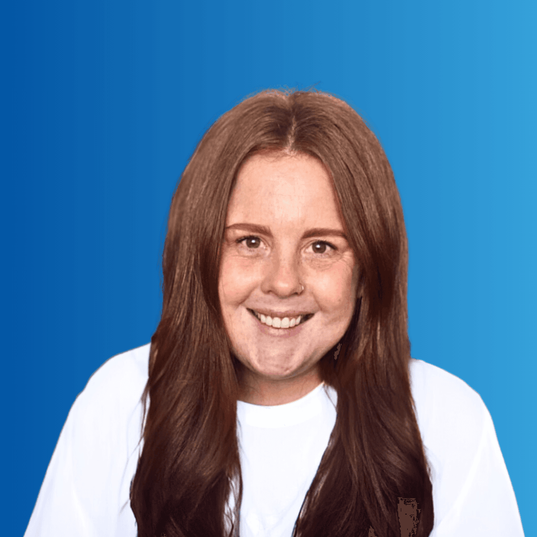 A woman smiling at the camera on a blue background
